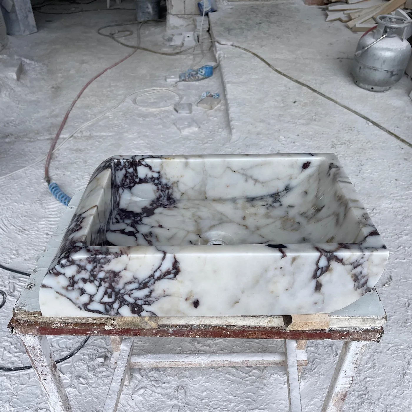 Calacatta Viola vessel basin, photographed in the workshop