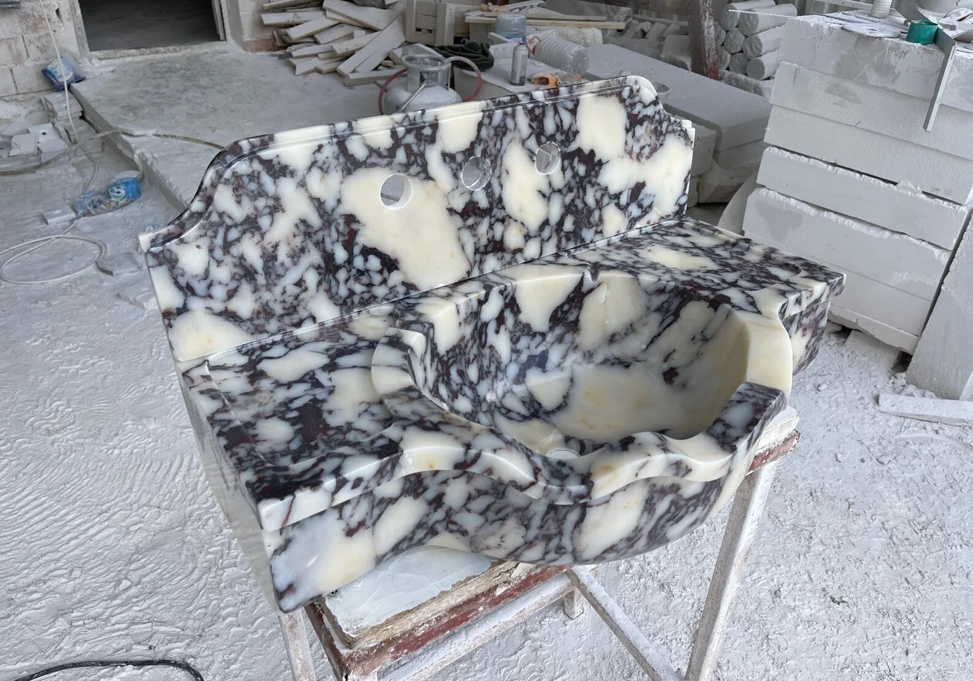 Calacatta Viola marble basin in the workshop, ivory with deep plum veins